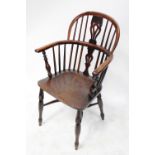 An 18th century elm-seated low-back Windsor armchair with yew wood back,