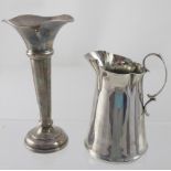 A hallmarked silver cream jug of plain conical form,