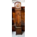 An oak grandmother clock of small proportions, the silvered dial set with Arabic numerals,