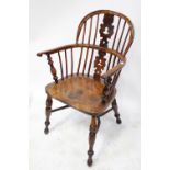 An 18th century elm-seated low-back Windsor armchair with yew wood back,