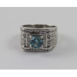 A white metal gentlemen's ring set with round-cut topaz and chip diamonds,