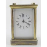 An early 20th century brass-cased carriage clock, the enamelled dial set with Roman numerals,