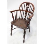 An 18th century elm-seated low-back Windsor armchair with yew wood back and crinoline stretcher.