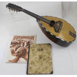 A 1920s Italian lute back mandolin with segmented rosewood back and spruce top,