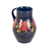 WILLIAM MOORCROFT; a large pomegranate decorated jug, signed to base with impressed marks to base,