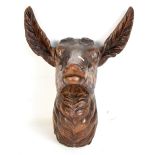 An early 20th century Black Forest carved deer head with glass eyes and lacking antlers, height