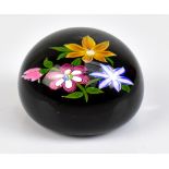 PERTHSHIRE; a circular glass paperweight, encased with floral sprays, signed P to cane and