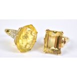 A 9ct yellow gold dress ring set with large oval cut yellow coloured stone and white stone chips