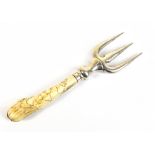 IN THE STYLE OF DR CHRISTOPHER DRESSER; a silver bladed bread fork with carved bone handle,