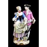 MEISSEN; a late 19th century figure group of a young couple, painted marks to base, also painted