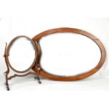 An Edwardian mahogany and inlaid oval swing mirror, 50.5 x 37cm, and an oval bevelled wall mirror.