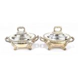 A pair of electroplated lidded twin handled tureens, with cast foliate handles, rims, and further