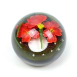 LUNDBERG STUDIOS; a limited edition glass paperweight encased with floral sprays and stars on a