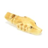 A carved bone whistle modelled as a dog's head, length 4.7cm.Additional InformationSome small