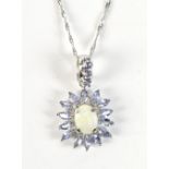 A white metal floral motif pendant set with tanzanite and opal, stamped 'Mexico 10k' to interior
