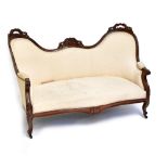A Victorian mahogany and cream upholstered sofa with serpentine front and shaped back, length