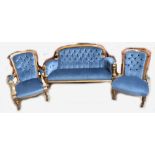 A late 19th century walnut three piece salon suite, comprising button backed canopy, elbow chair and