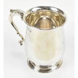ASPREY; a George V hallmarked silver mug, with loop handles and spreading circular foot, London