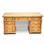 A modern hardwood pedestal desk with stone panel inlay, six draws and one cupboard, width 165cm.