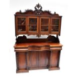 A Victorian mahogany serpentine fronted sideboard, with three drawers above four panelled cupboard