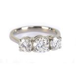 A good platinum and diamond three stone ring, the central brilliant cut stone weighing 0.92cts,