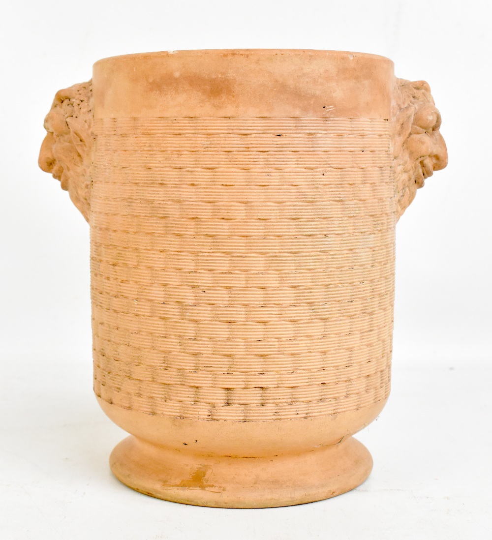 DAVENPORT; a terracotta vase with Bacchanalian moulded masks and basket weave effect to the body,