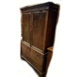A 19th century mahogany linen press with moulded cornice above twin doors, the base with two short