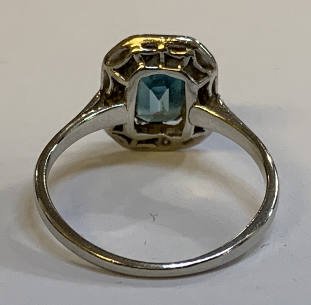 An Art Deco white metal diamond set cocktail ring with central emerald cut stone within a border - Image 2 of 3