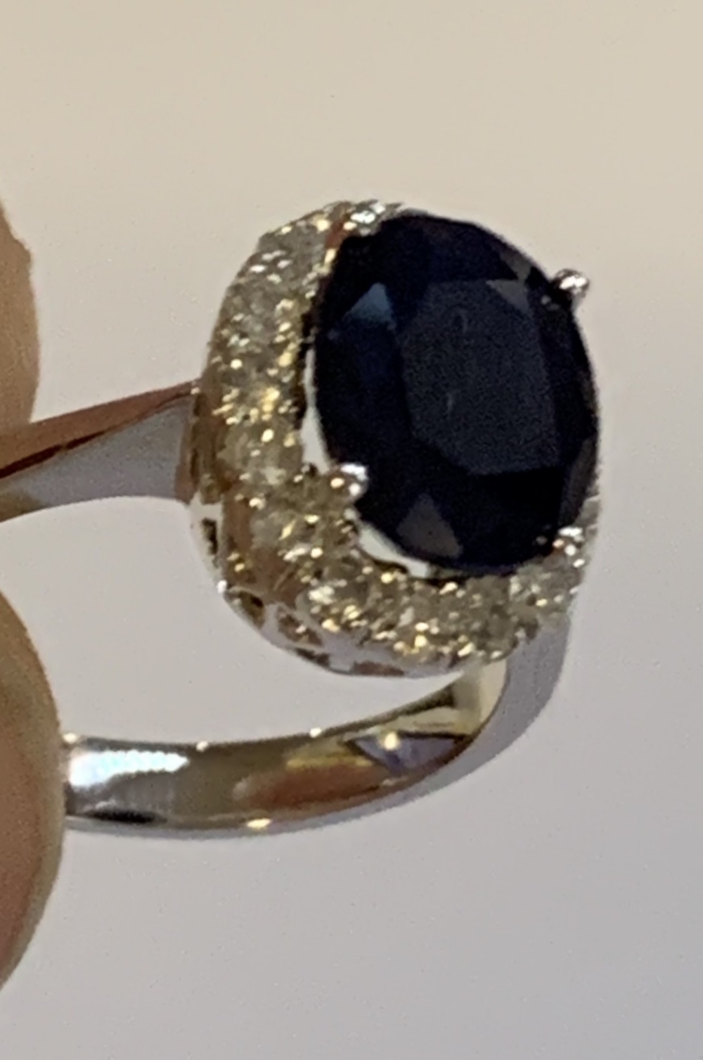 A white metal diamond and sapphire cluster ring, the modified brilliant cut sapphire weighing approx - Image 5 of 5