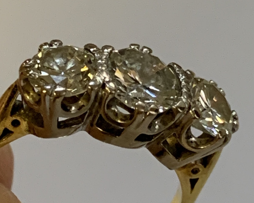 An 18ct yellow gold and diamond three stone ring, the central round brilliant cut stone weighing - Image 7 of 8