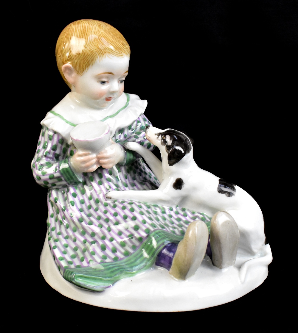 MEISSEN; a 20th century figure group of a young child seated with a puppy at their feet, painted