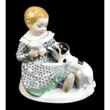 MEISSEN; a 20th century figure group of a young child seated with a puppy at their feet, painted