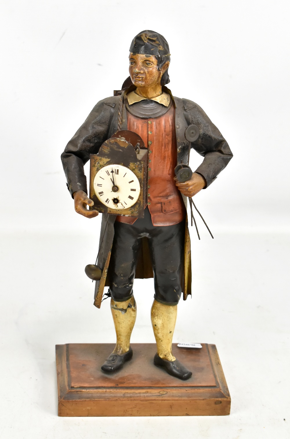 A late 19th century tole ware painted tin mantle time piece modelled as a clock salesman with wall