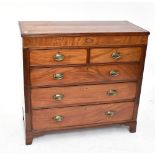 A Georgian inlaid mahogany chest of two short over three long drawers raised on bracket feet.