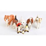 A group of five Beswick dogs including Lochinvar of Lady Park, spaniel, etc, also a trio of penguins
