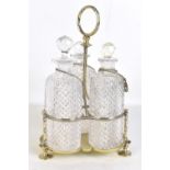 A late Victorian silver plated three bottle tantalus, with hobnail cut oval decanters, height 32cm.