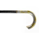 A Chinese white and yellow metal handled walking cane, with ebonised shaft and decorated with