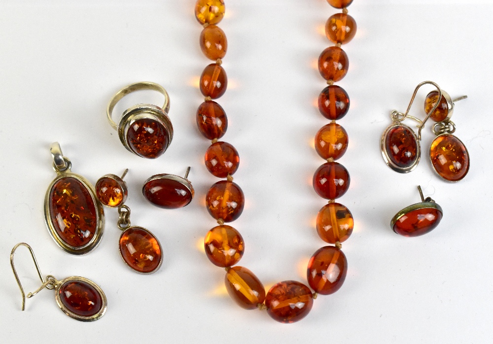 A group of amber jewellery to include a graduated beaded necklace, a pendant and earrings, etc.