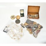 A quantity of costume jewellery including beads, necklaces, vintage earrings, cuff links, and