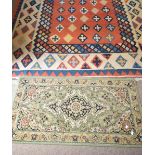 A needlepoint rug with stylised geometric design on a cream ground, 310 x 206cm, and a Middle