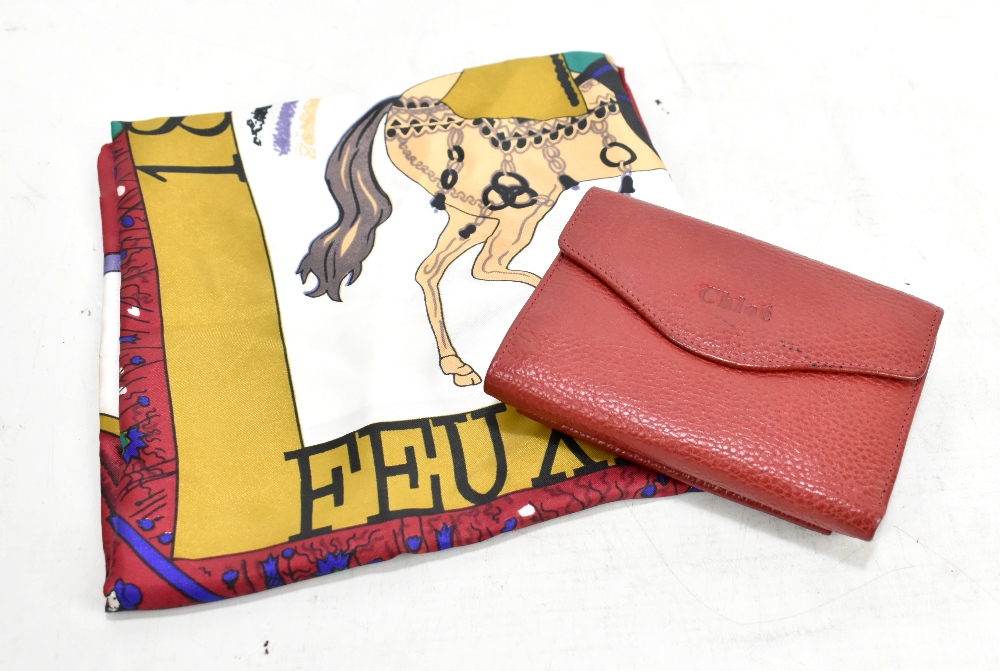 CHLOE; a red leather purse with pebbled leather texture with a printed logo to the front, 14 x 10