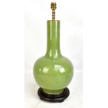 A Chinese celadon crackle glazed lamp base fitted on circular hardwood stand, height excluding