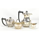 GF WESTWOOD & SONS; a George V hallmarked silver three piece tea service, with gadrooned detail,
