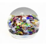 A 20th century glass paperweight with scramble decoration, diameter 8cm.