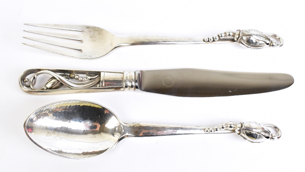 GEORG JENSEN; a Danish sterling silver 'Blossom' pattern knife, fork, and spoon set, all bearing