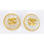CHANEL; a pair of 1995 costume faux pearl round clip on earrings featuring interlocking CC logo,