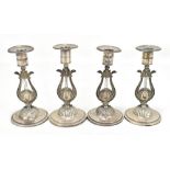 A set of four Swedish .830 silver candlesticks, each with circular sconce raised on lyre form