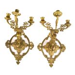 A pair of late 19th century ormolu three branch wall lights with elaborate pierced back plates.