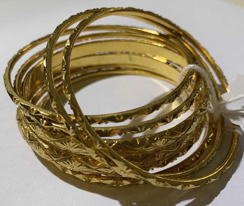 **AMENDED DESCRIPTION** Eight yellow metal bangles, six x 2mm diameter and two x 5mm diameter, total - Image 2 of 2