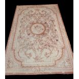 An Aubusson type tapestry with floral detail on peach ground, 275 x 178cm.